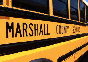 Side view of yellow Marshall County Schools bus.